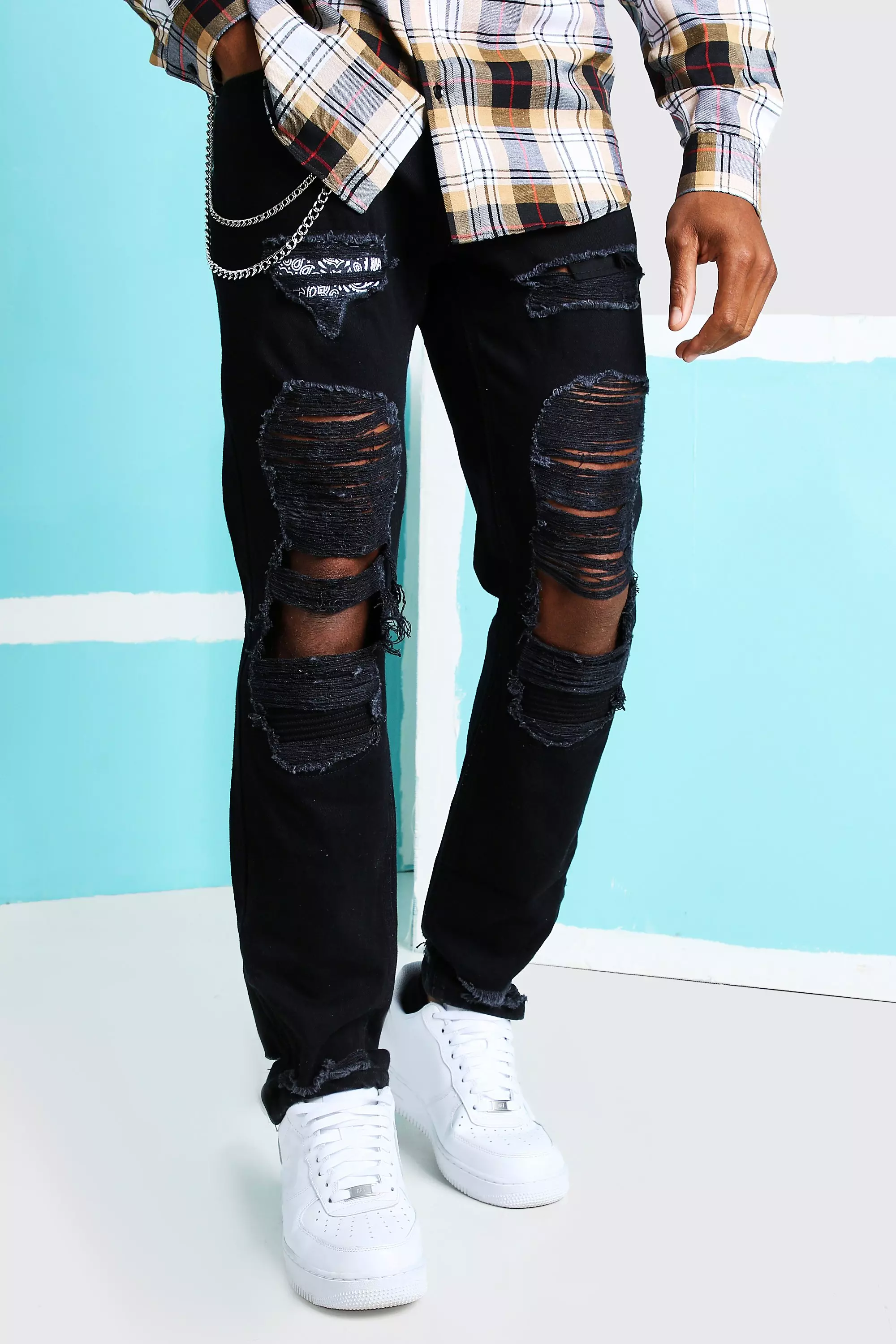 Ripped jeans with store chains on them